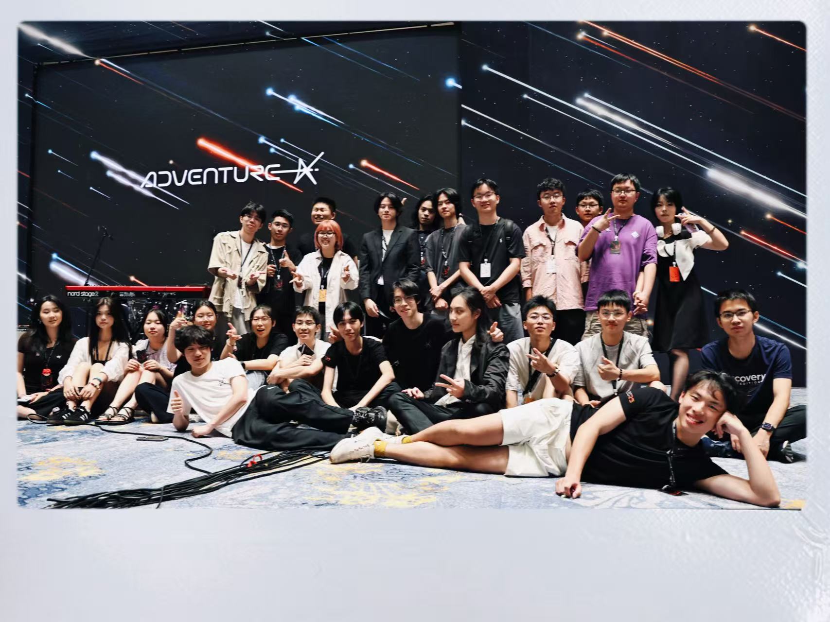 Group photo in front of the AdventureX stage