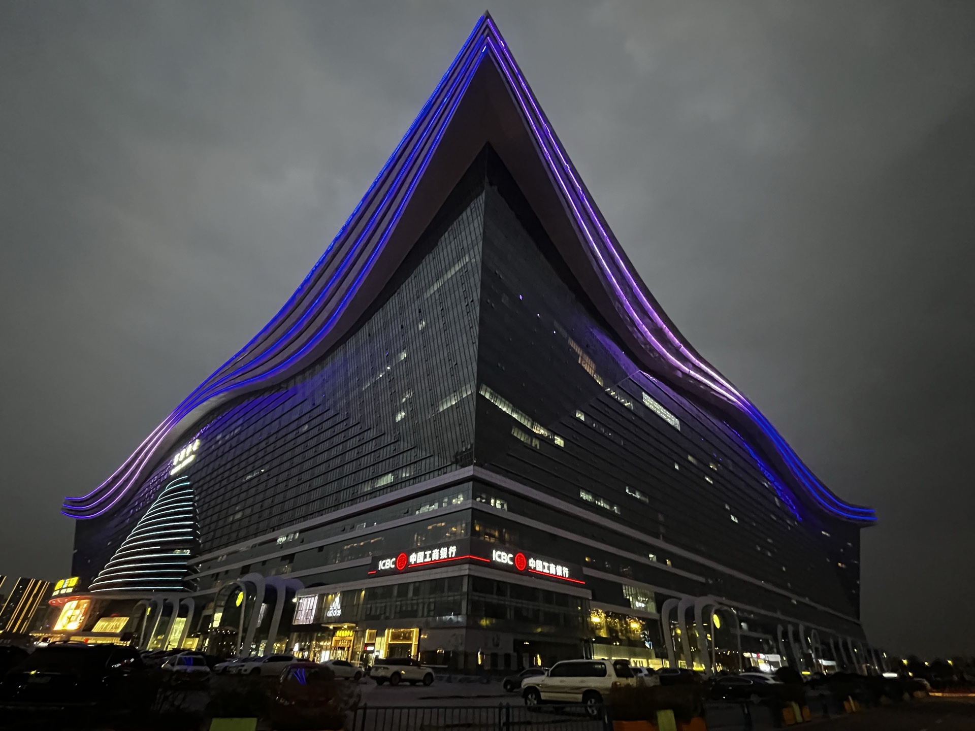 A building illuminated with purple lights at night